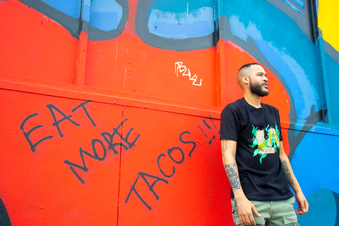 man in black crew neck t-shirt standing beside red wall