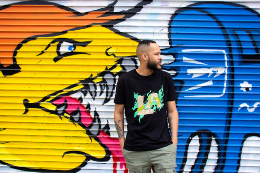 man in black crew neck t-shirt standing beside yellow and blue surfboard