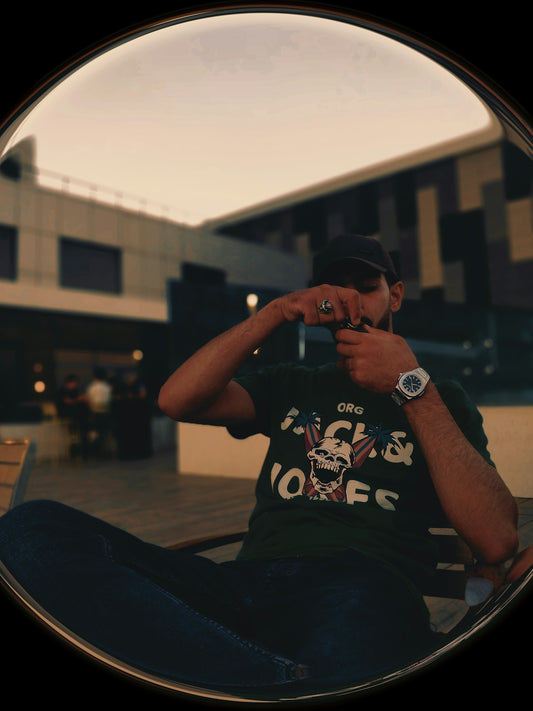 Man in a dark t-shirt taking a picture