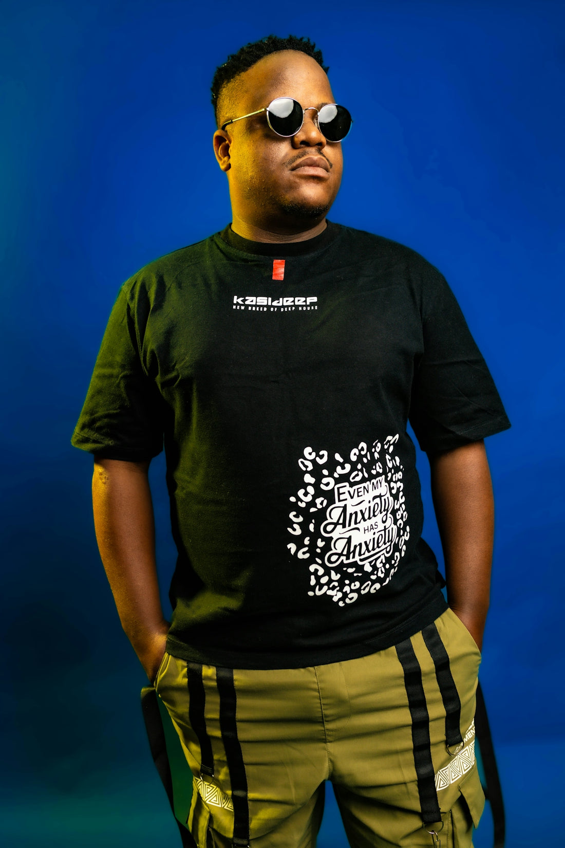 Man in black t-shirt and sunglasses posing
