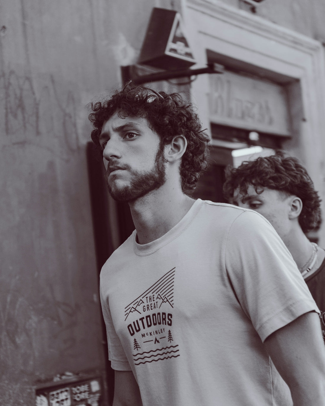 Man with curly hair wearing a t-shirt