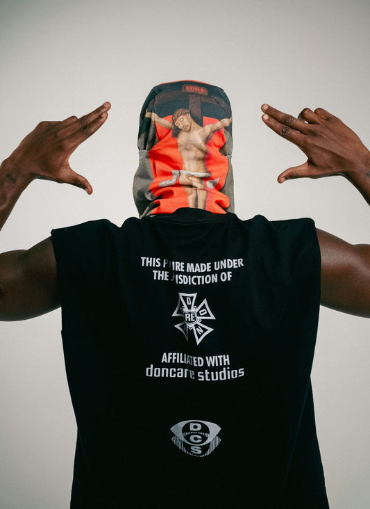 Person wearing a shirt and mask with religious imagery