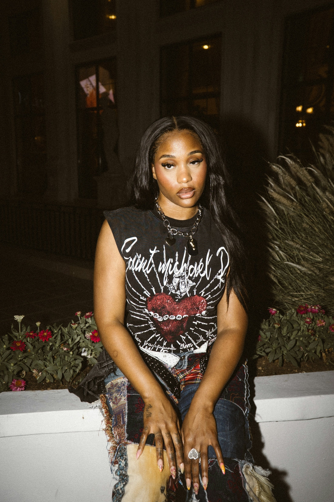 A young woman wearing a graphic t-shirt and distressed jeans.