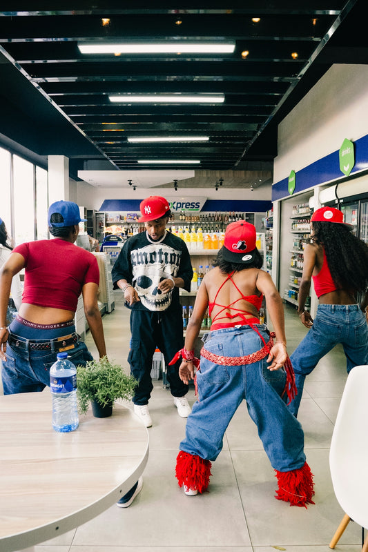 Four people dancing in a convenience store