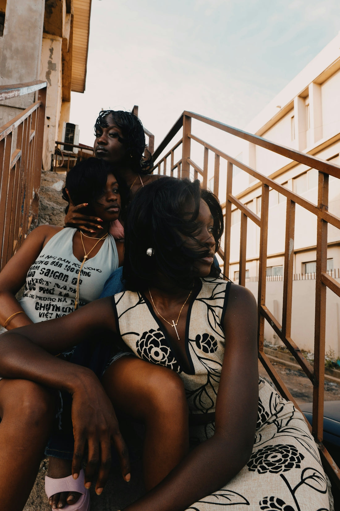 Three young women sitting on outdoor stairs
