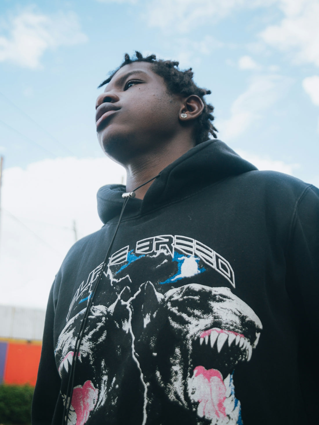 Young man in a black hoodie with dog graphic