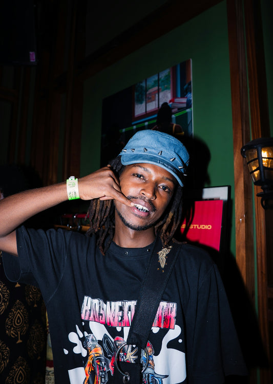 Young man wearing a blue cap and black t-shirt