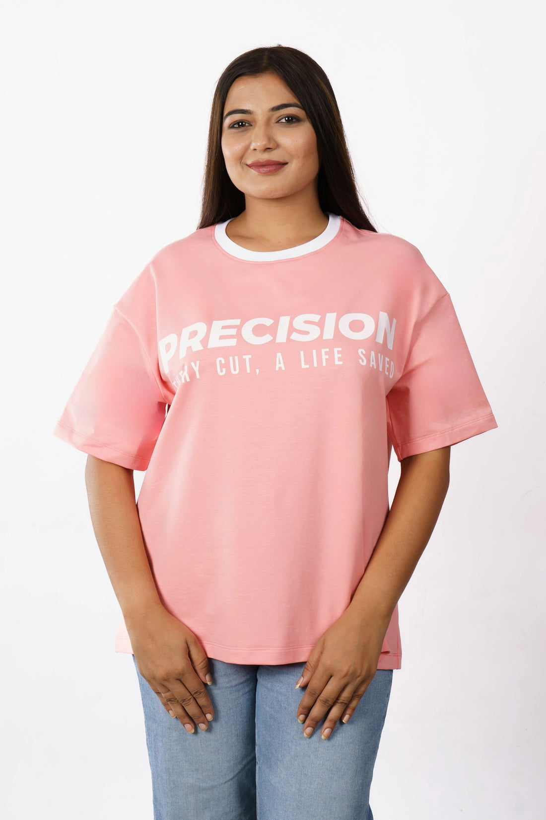 A woman wearing a pink t-shirt with text