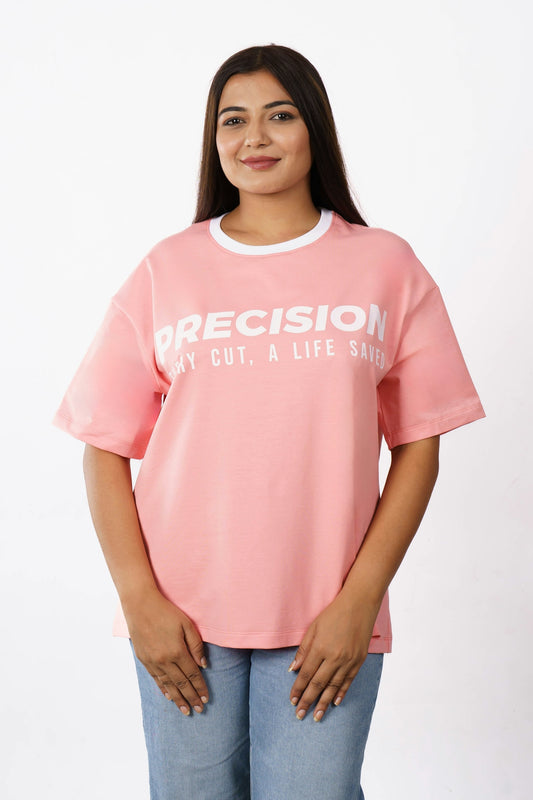 A woman wearing a pink t-shirt with text