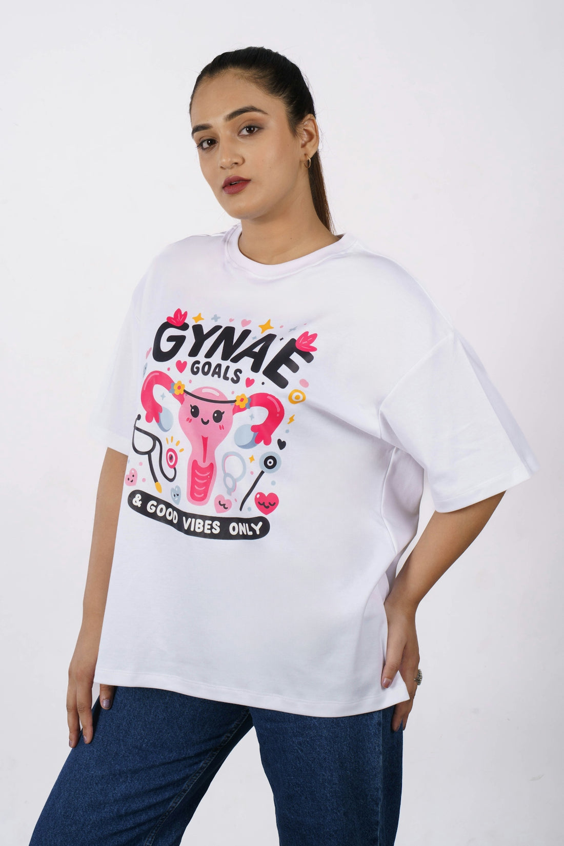 Woman wearing a white t-shirt with gynae goals graphic.