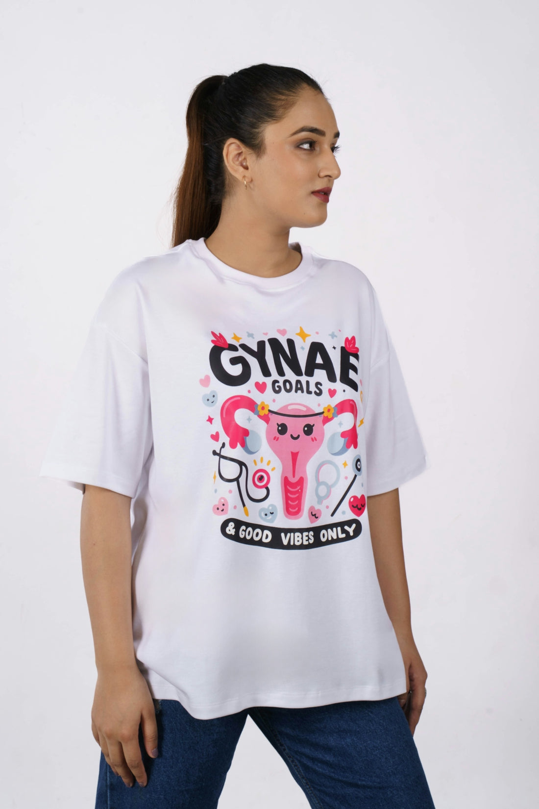 Woman wearing a white t-shirt with uterus graphic.