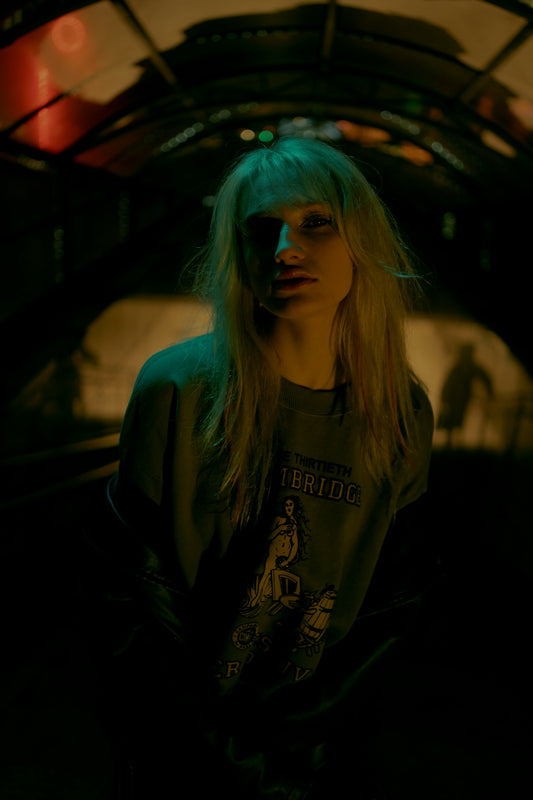 Woman with blonde hair in a dimly lit tunnel