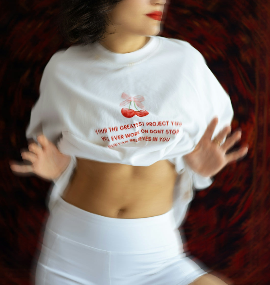 Woman in white shirt and shorts with text.