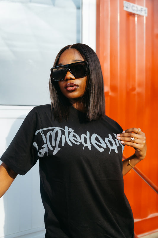 A woman wearing sunglasses and a t-shirt