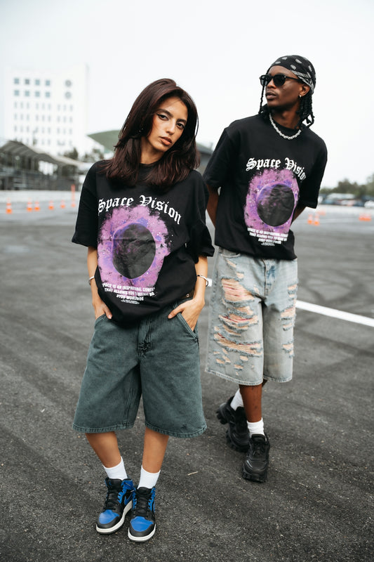 Two people wearing matching t-shirts with graphic design.